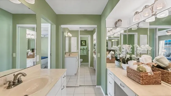 a spacious bathroom with a granite countertop sink a mirror and a shower