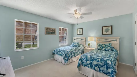 a bedroom with three beds and a window