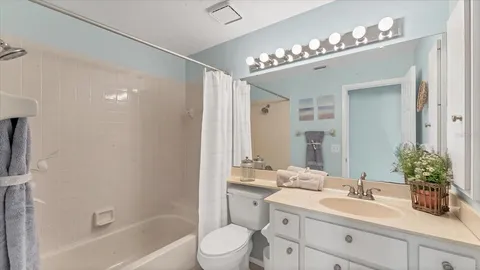 a bathroom with a sink a large mirror and a shower