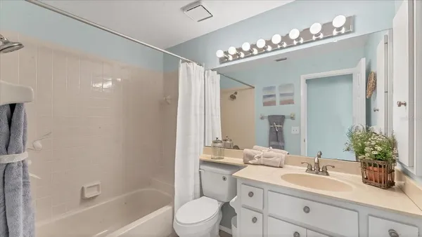 a bathroom with a sink a large mirror and a shower