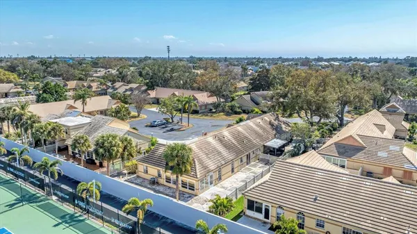a view of a balcony with dining table and chairs