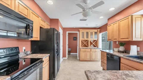 a kitchen with stainless steel appliances granite countertop a refrigerator stove and sink