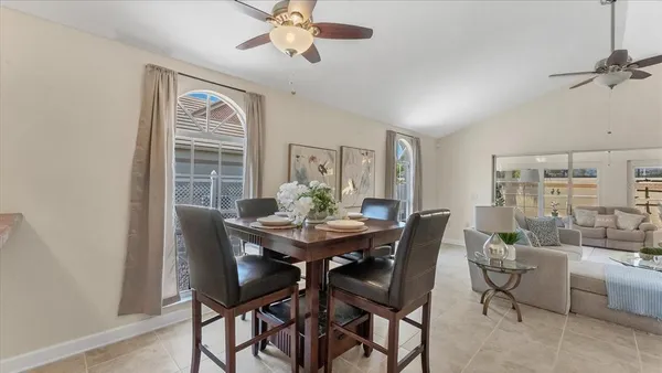a view of a dining room with furniture and a chandelier