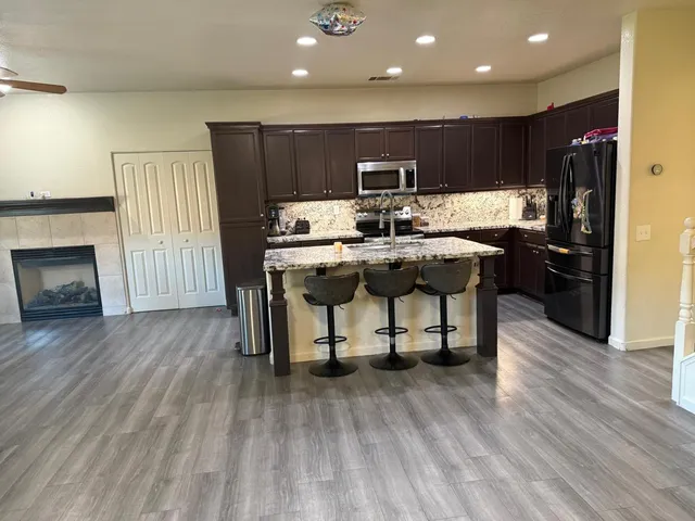 a view of a kitchen with a table and chairs