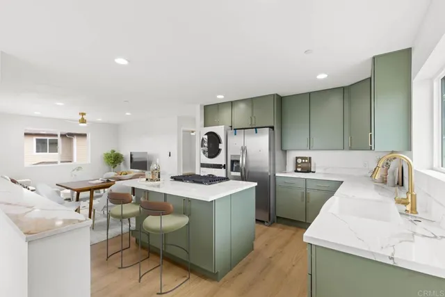 a kitchen with refrigerator and chairs