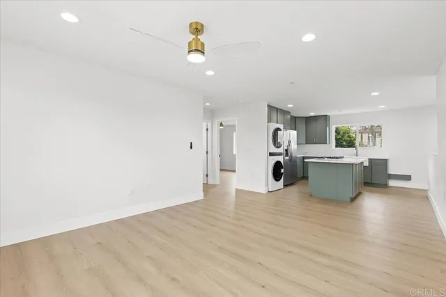 a view of a kitchen with a sink and a refrigerator