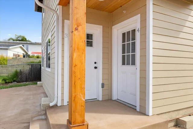 an empty room with a kitchen and windows