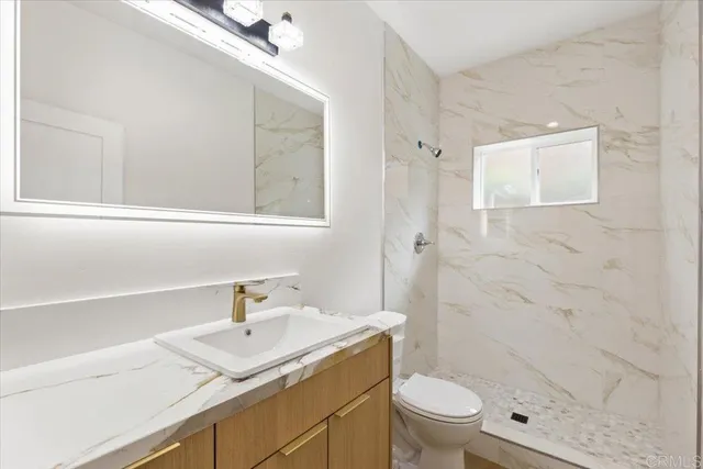 an empty room with wooden floor and window