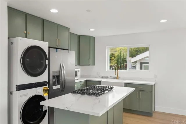 a view of a kitchen with a sink and a refrigerator