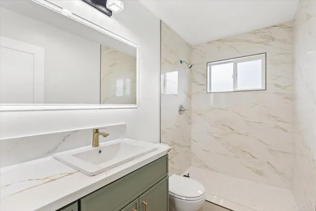 an empty room with wooden floor and window