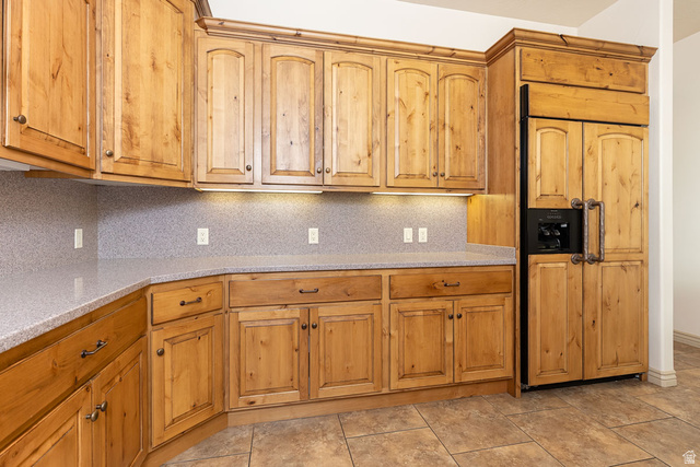 888 East Fiddlers Canyon Road Cedar City, UT 84721 - Photo 17 of 74 Kitchen featuring backsplash, paneled built in refrigerator, light stone counters, and wood finish cabinets