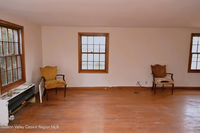 a living room with furniture a piano and a window