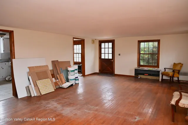a view of a livingroom with lounge chair and a window
