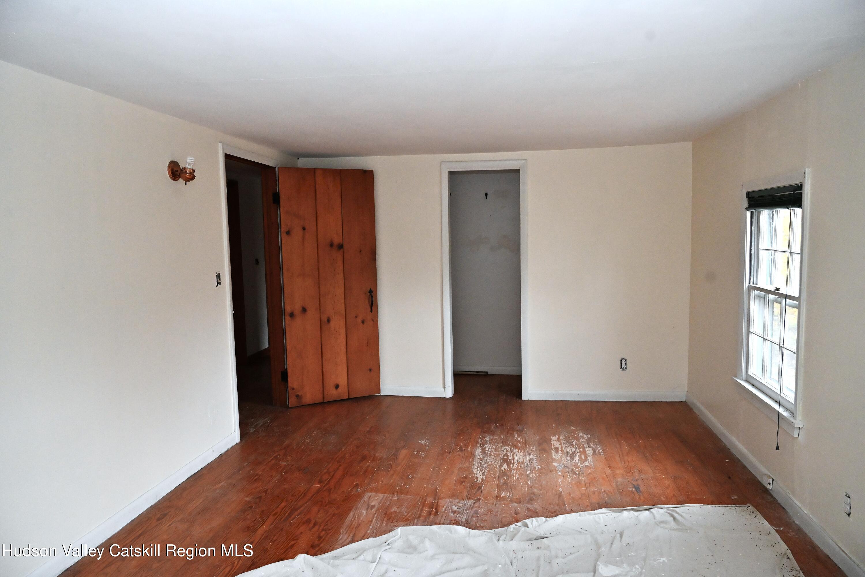 163 County Rte 14 Hudson, NY 12534 - Photo 18 of 49 a view of an empty room with wooden floor and window