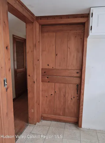 a room with a table chairs and a window