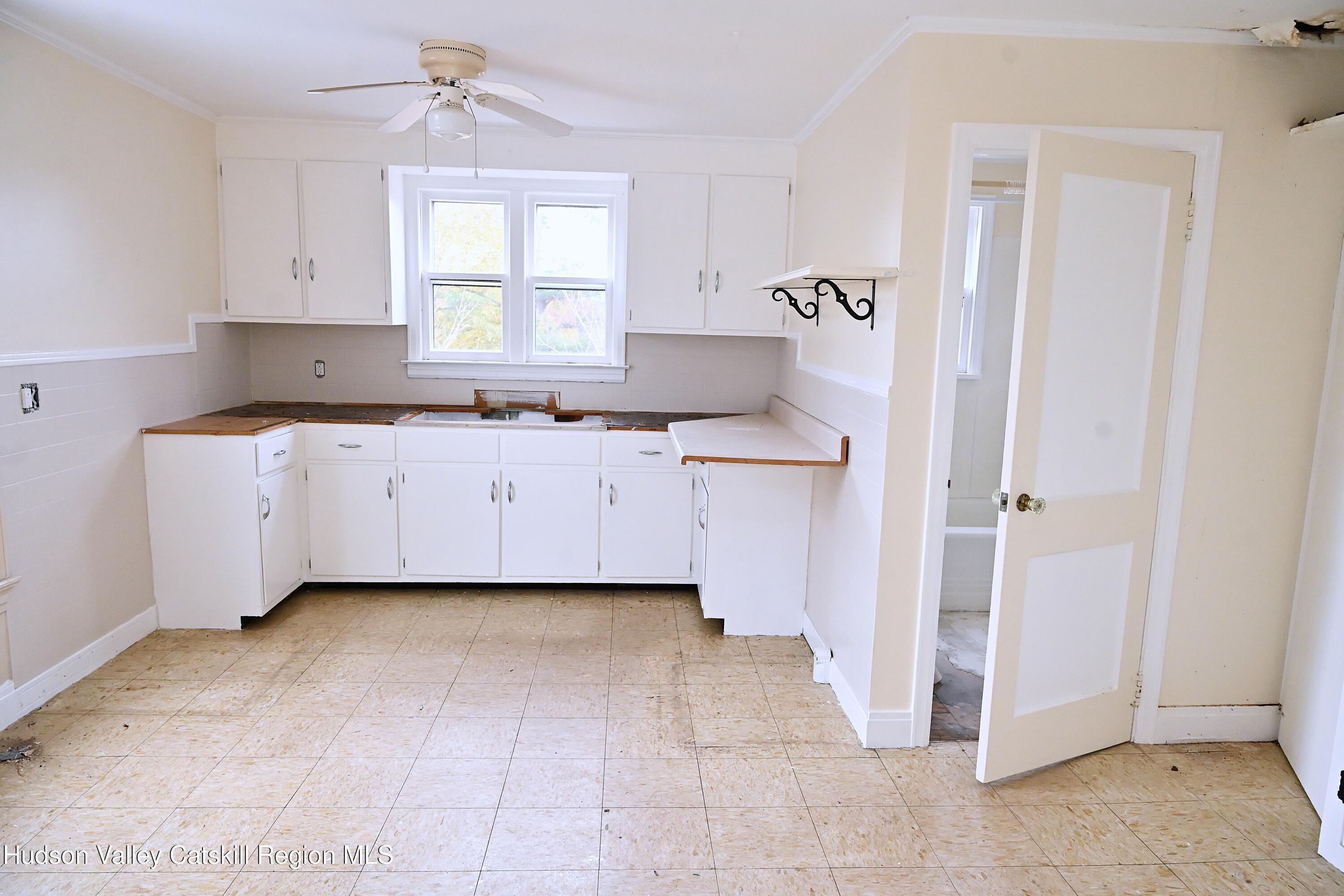163 County Rte 14 Hudson, NY 12534 - Photo 26 of 49 a kitchen with a sink a window and cabinets