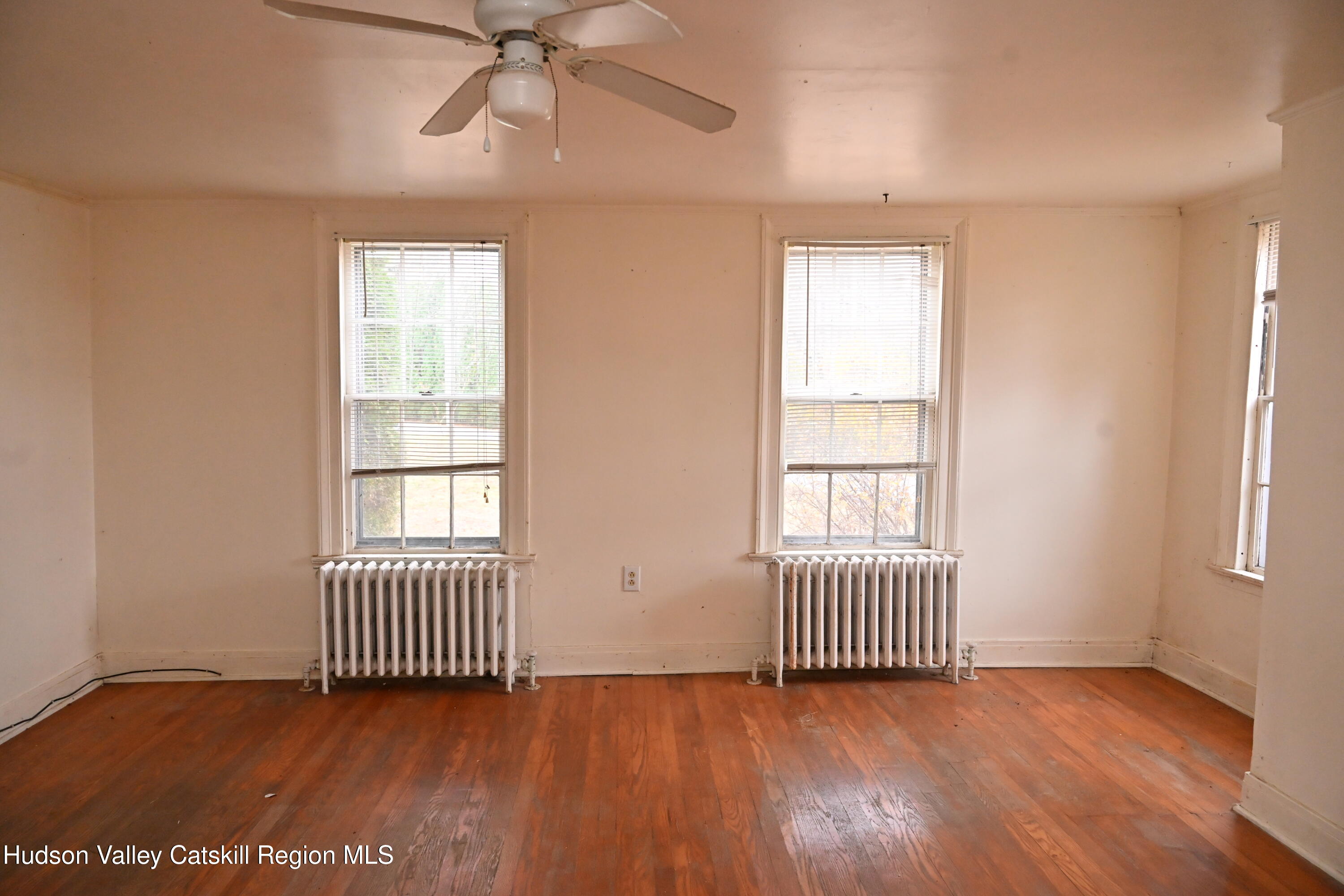 163 County Rte 14 Hudson, NY 12534 - Photo 29 of 49 an empty room with wooden floor and windows