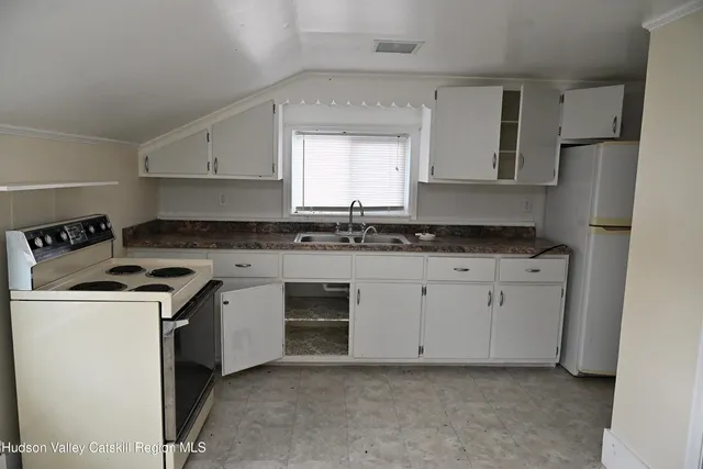 a view of an empty room and closet area