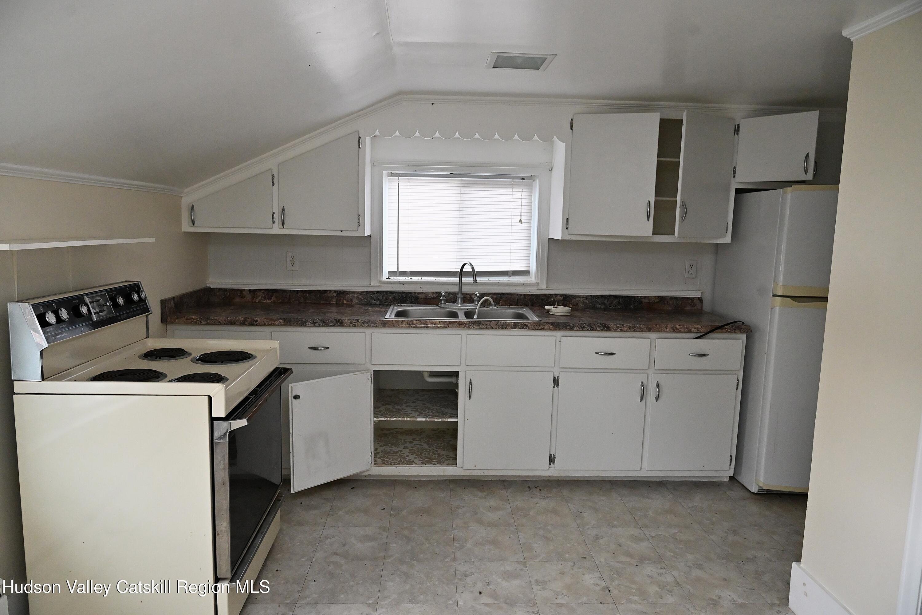 163 County Rte 14 Hudson, NY 12534 - Photo 32 of 49 a kitchen with granite countertop a sink stove and refrigerator