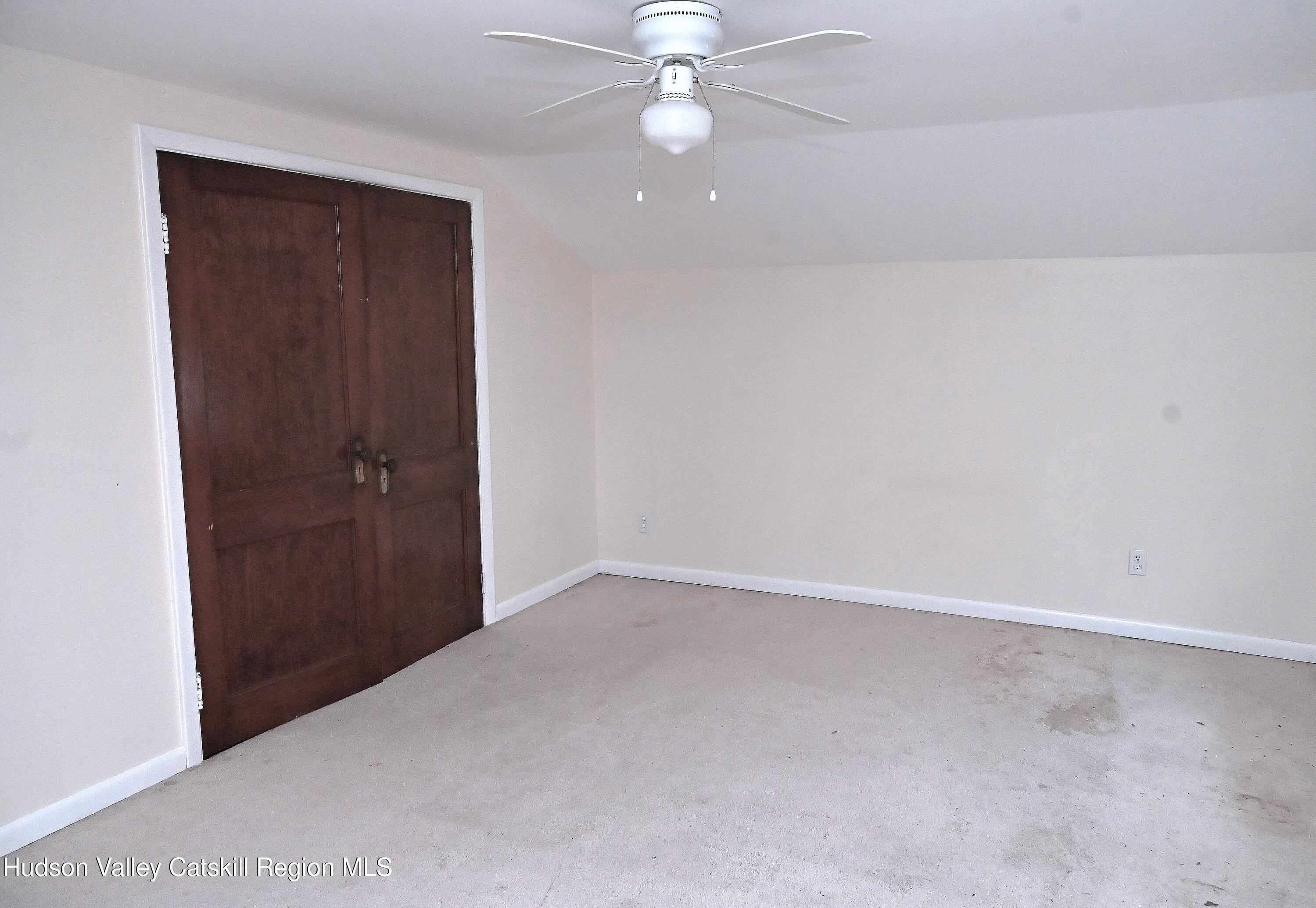 163 County Rte 14 Hudson, NY 12534 - Photo 34 of 49 an empty room with a ceiling fan and a window