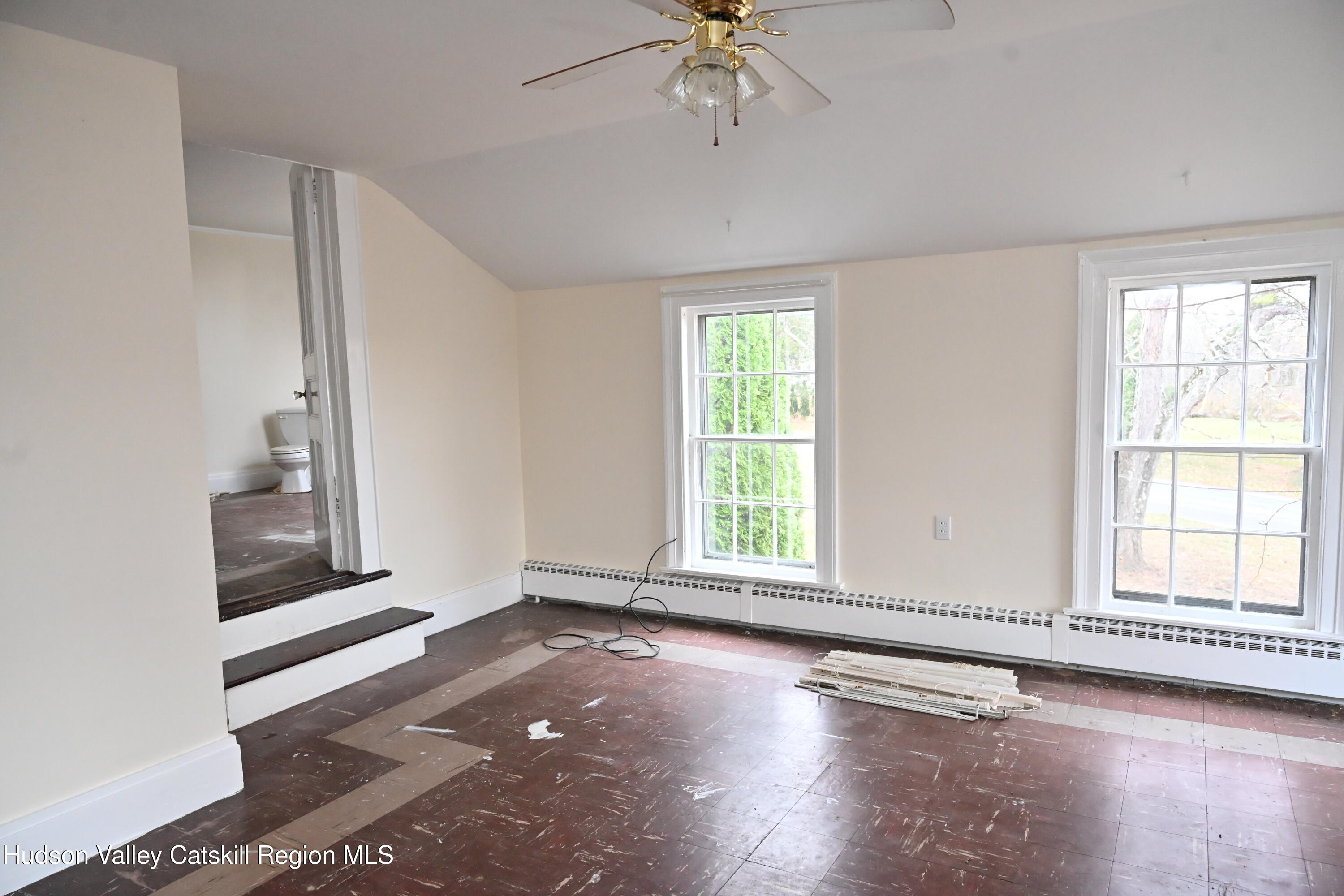 163 County Rte 14 Hudson, NY 12534 - Photo 42 of 49 an empty room with wooden floor fan and windows