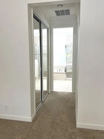 a view of hallway with wooden floor