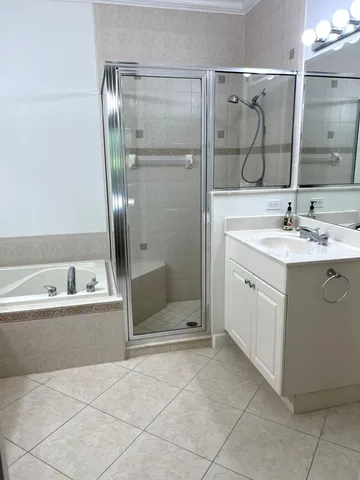 a bathroom with a bathtub sink and mirror