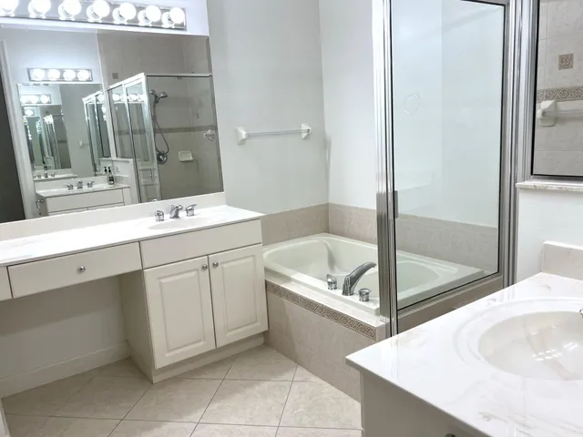 a bathroom with a tub sink and mirror