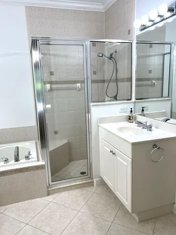 a bathroom with a shower sink and mirror