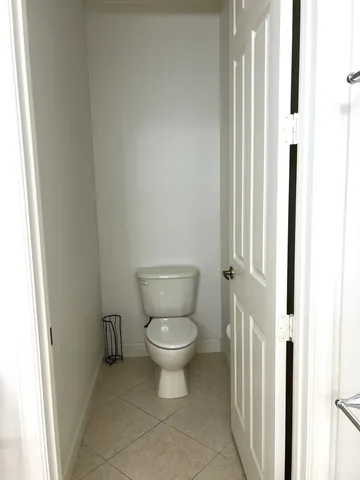 a white toilet sitting next to a window