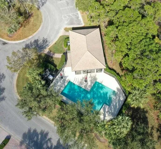 an aerial view of a house with a yard and trees