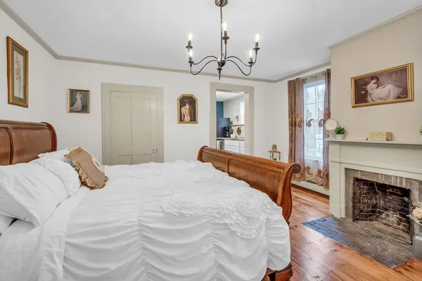 a bedroom with a bed and a fireplace