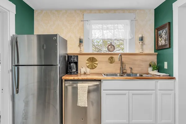 a kitchen with stainless steel appliances granite countertop a refrigerator and a sink