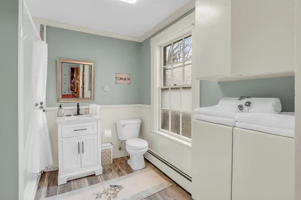 a bathroom with a sink toilet and shower