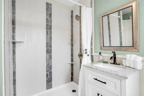 a bathroom with a sink and a mirror with toilet