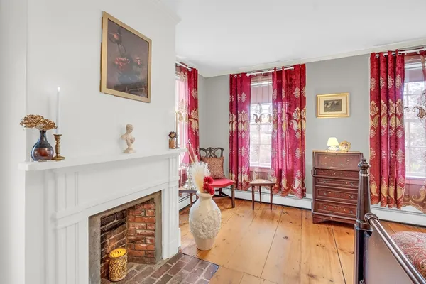 a view of a living room with furniture and a fireplace