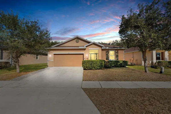 a front view of a house with a yard and garage