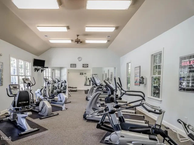 a view of a chairs and table in patio with a barbeque