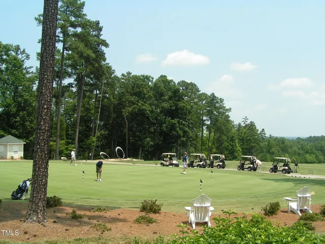 a backyard of a house with a yard and outdoor seating