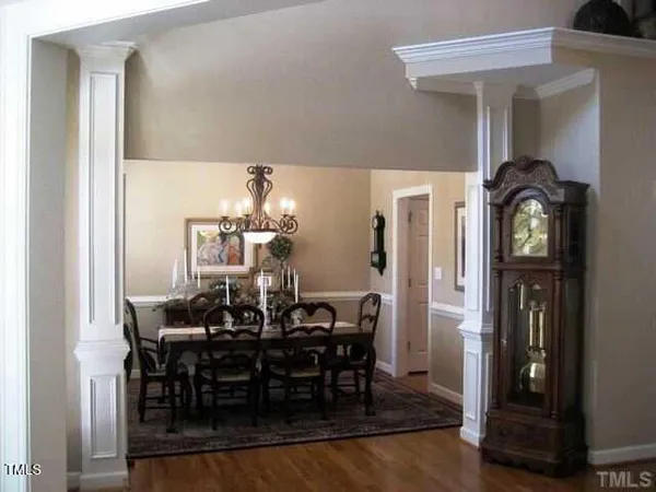 a view of a dining room with furniture and chandelier