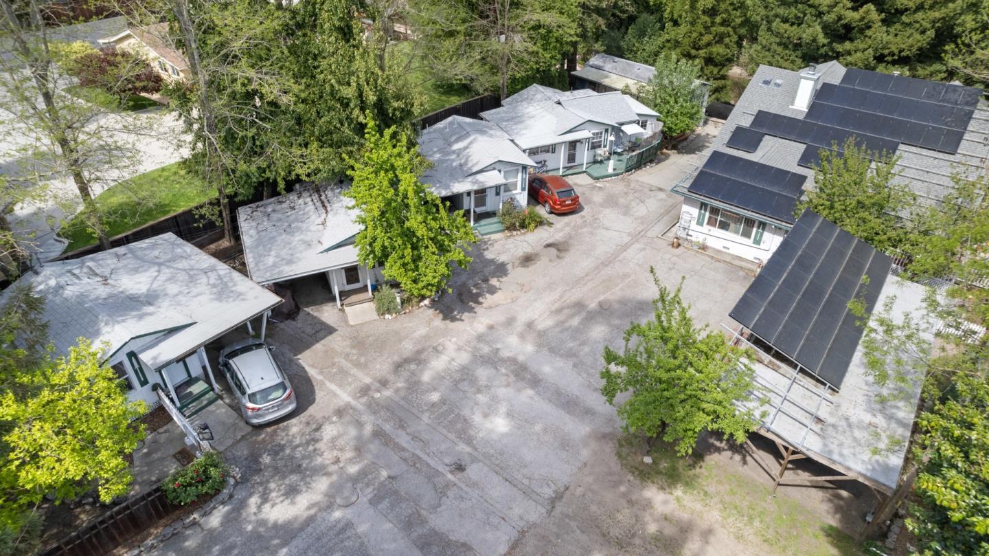 an aerial view of a house with garden space and street view