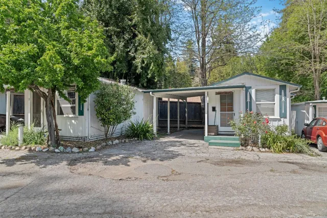 a front view of a house with a garden