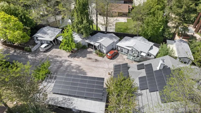 an aerial view of a house with a yard and garden