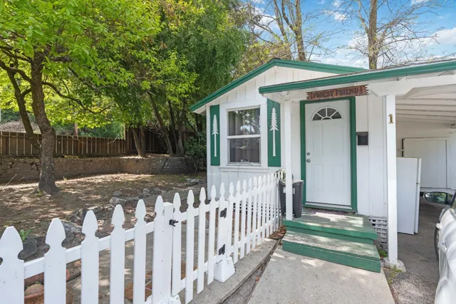 a view of a house with wooden fence