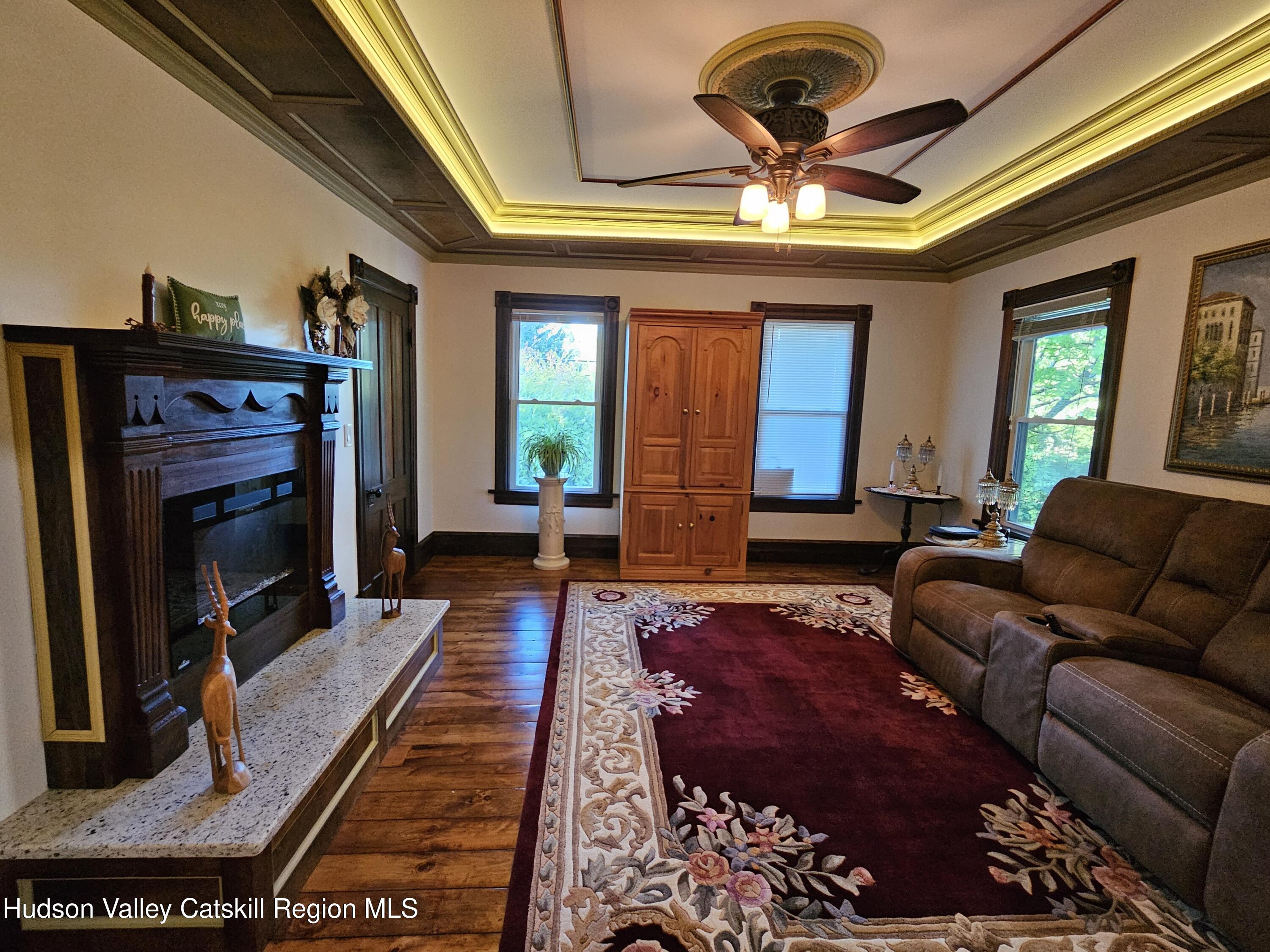 463 Cairo Junction Road Catskill, NY 12414 - Photo 16 of 35 a living room with furniture a fireplace and a flat screen tv