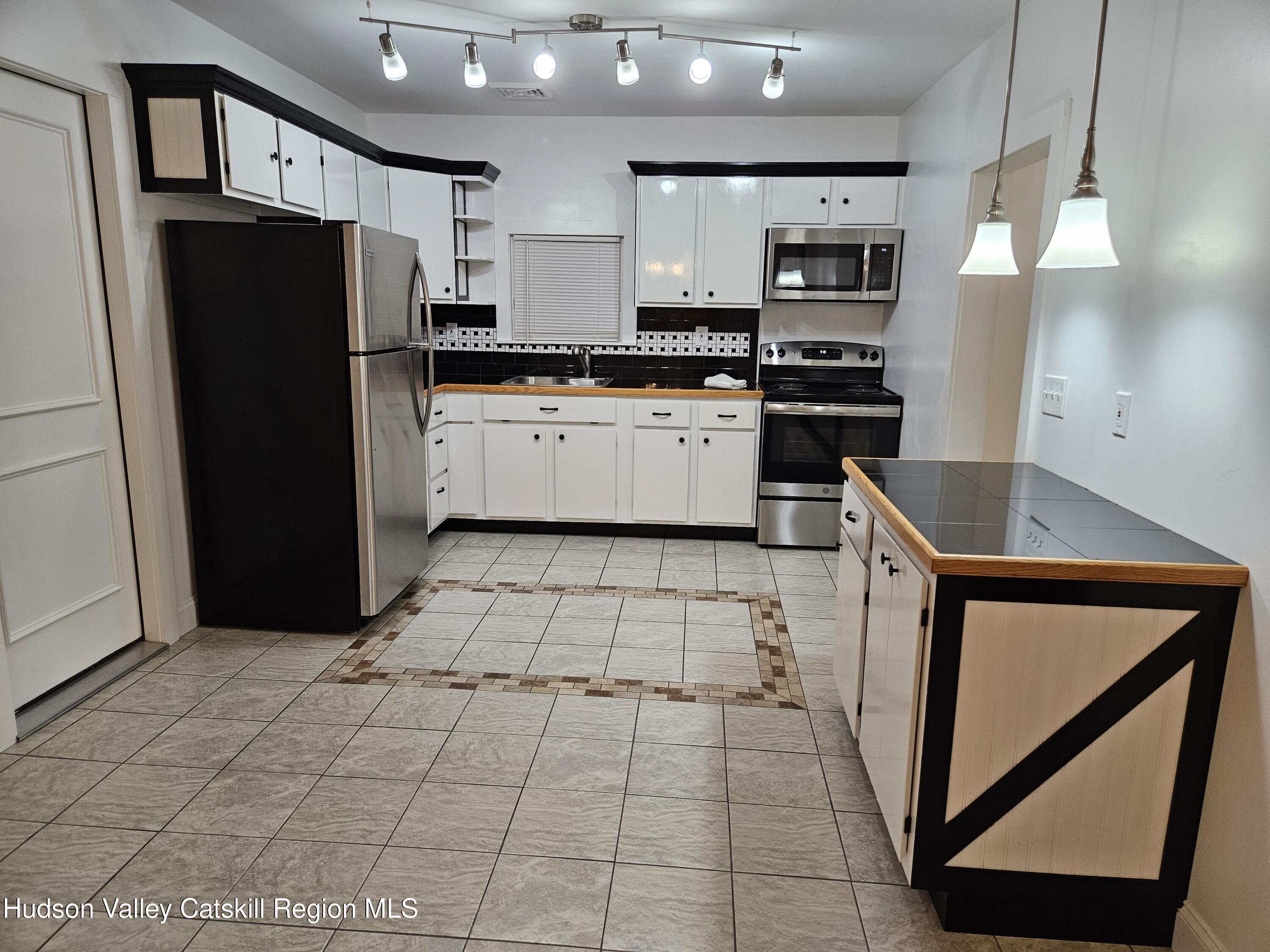 463 Cairo Junction Road Catskill, NY 12414 - Photo 27 of 35 a kitchen with stainless steel appliances granite countertop a refrigerator and a stove top oven