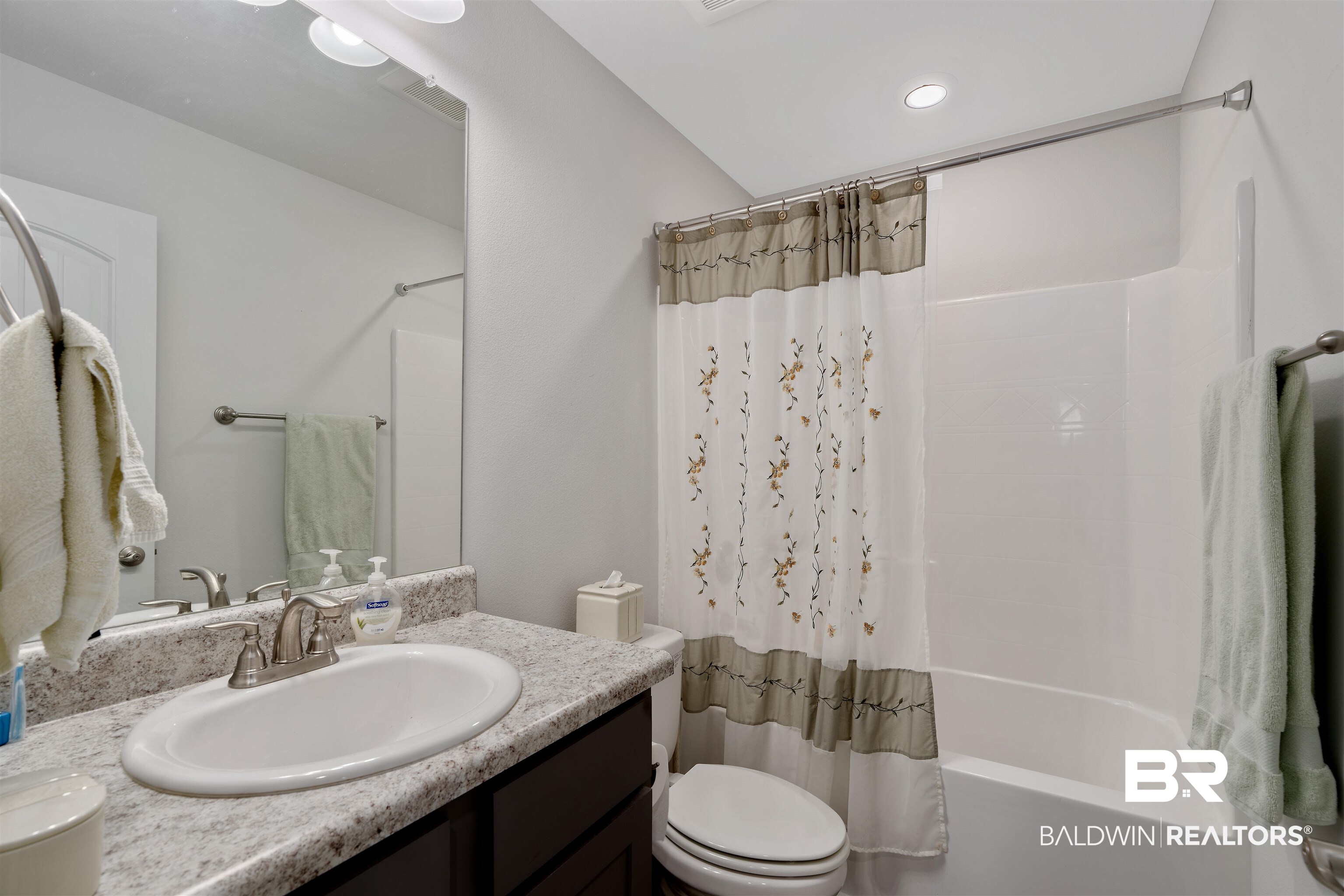 8823 Allay Lane Foley, AL 36535 - Photo 14 of 18 Full bathroom featuring vanity, toilet, and shower / bath combination with curtain