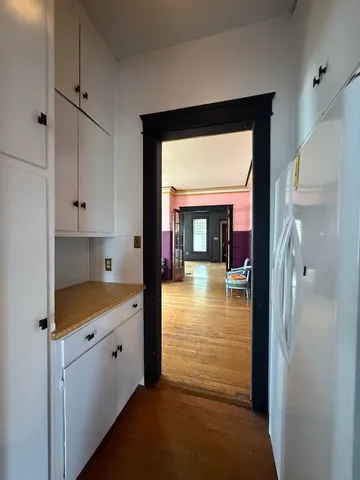 a kitchen with white cabinets and a fireplace