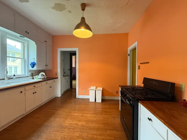 a kitchen with stainless steel appliances granite countertop a sink and cabinets