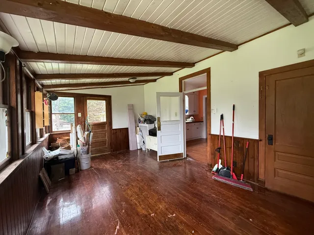 a living room with furniture stairs and a wooden floor